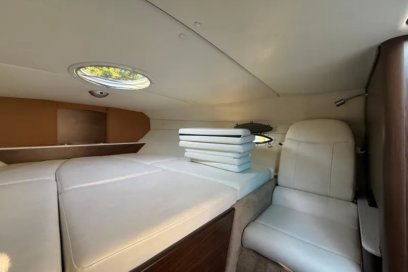 Slide: The Image of Interior cabin of 2017 Rinker QX23 CC boat with seating and cushions. - 21