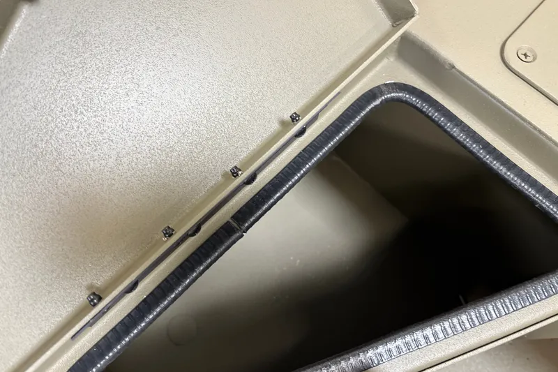Slide: The Image of Storage compartment of 2027 Tracker Grizzly 1756 T Marsh boat, open lid view. - 15