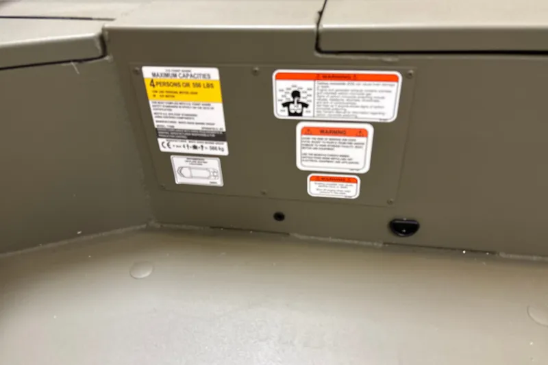 Slide: The Image of 2027 Tracker Grizzly 1756 T Marsh boat capacity and warning labels on interior panel. - 20