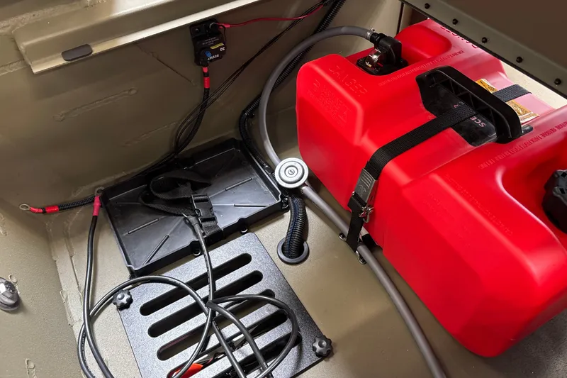 Slide: The Image of Interior of 2027 Tracker Grizzly 1756 T Marsh boat with red fuel tank and wiring. - 19