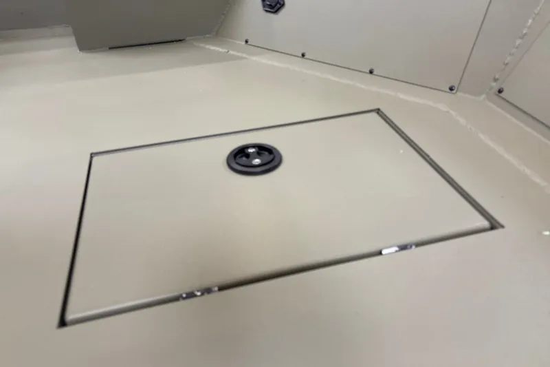 Slide: The Image of 2027 Tracker Grizzly 1756 T Marsh boat storage compartment with secure latch. - 13