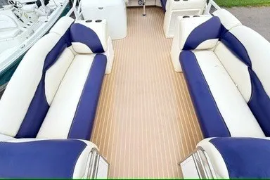 Slide: The Image of 2006 JC 23 Neptoon TT boat interior with blue and white seating and wooden deck. - 7