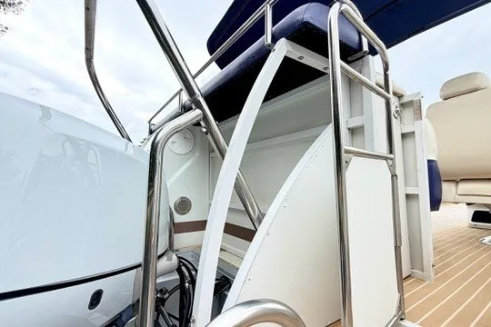 Slide: The Image of 2006 JC 23 Neptoon TT boat with triple tube design and stainless steel railings. - 23
