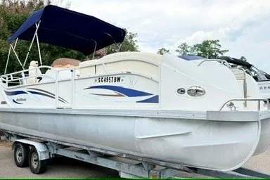 Slide: The Image of 2006 JC 23 Neptoon TT Triple Tube pontoon boat on trailer with canopy. - 2
