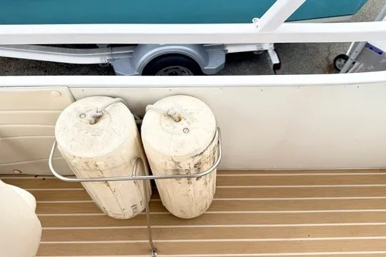 Slide: The Image of 2006 JC 23 Neptoon TT boat deck with fenders and trailer in view. - 21