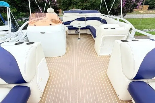 Slide: The Image of 2006 JC 23 Neptoon TT boat interior with white and blue seating. - 9
