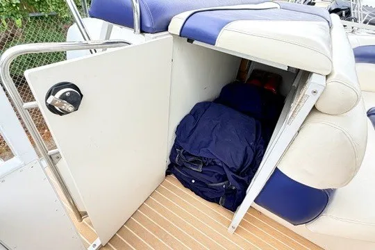 Slide: The Image of Storage compartment on a 2006 JC 23 Neptoon TT boat with blue and white seating. - 19