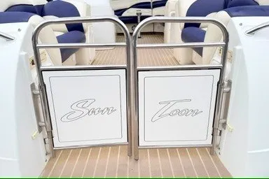 Slide: The Image of 2006 JC 23 Neptoon TT boat gate with "Sun Toon" design, featuring blue and white seating. - 5