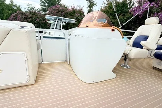Slide: The Image of 2006 JC Neptoon TT boat interior with helm and seating on deck. - 12