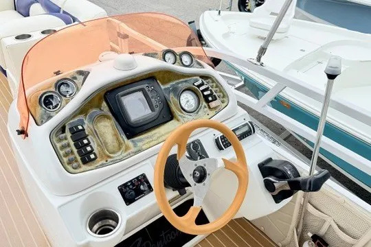 Slide: The Image of Control panel of a 2006 JC 23 Neptoon TT Triple Tube boat with steering wheel and gauges. - 16