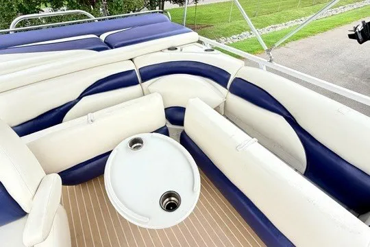 Slide: The Image of 2006 JC 23 Neptoon TT boat interior with blue and white seating and round table. - 14