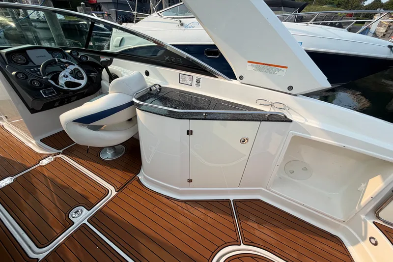 Slide: The Image of 2013 Monterey 264FSX boat interior with sleek dashboard and luxurious seating. - 7