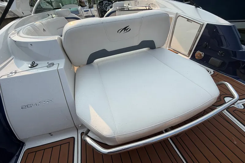 Slide: The Image of 2013 Monterey 264FSX boat with white seating and teak-style flooring. - 1