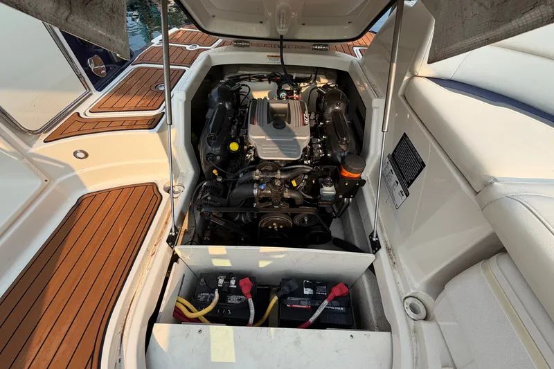 Slide: The Image of Engine compartment of a 2013 Monterey 264FSX boat with visible battery and components. - 6