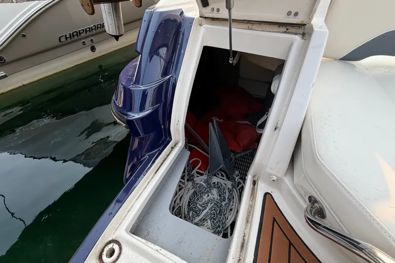 Slide: The Image of Open storage compartment on a 2013 Monterey 264FSX boat, containing ropes and equipment. - 2