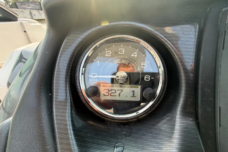 Slide: The Image of Close-up of a 2013 Monterey 264FSX tachometer displaying 327.1 engine hours. - 12