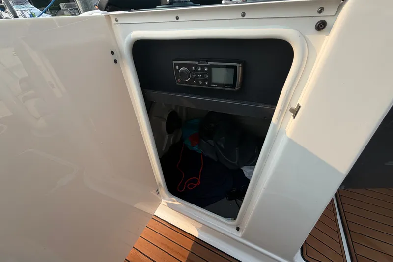 Slide: The Image of Storage compartment with stereo system on a 2013 Monterey 264FSX boat. - 16