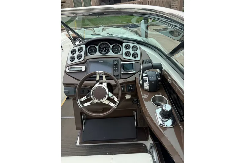 Slide: The Image of Cockpit of 2016 Monterey 328SS Super Sport boat with steering wheel and control panel. - 27