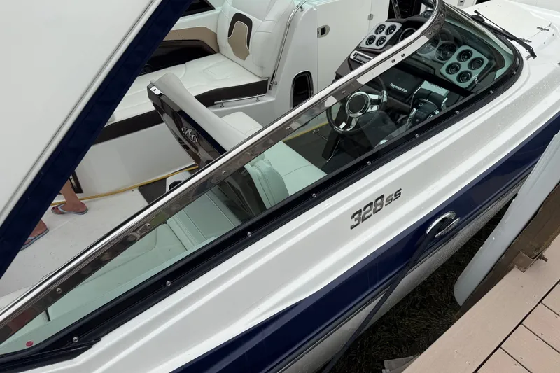 Slide: The Image of 2016 Monterey 328SS Super Sport boat interior with steering wheel and seating. - 2