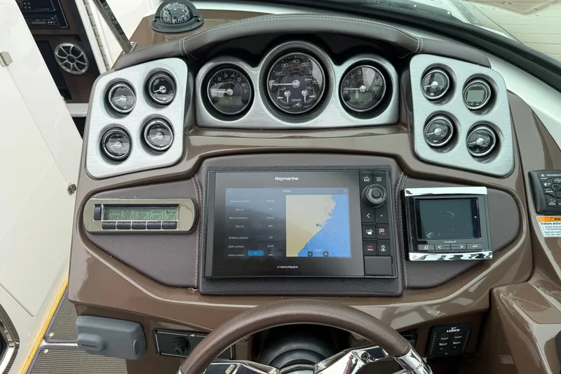 Slide: The Image of Dashboard of a 2016 Monterey 328SS Super Sport boat with navigation and control systems. - 31