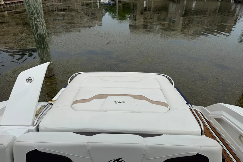Slide: The Image of 2016 Monterey 328SS Super Sport boat with white seating, docked by calm waters. - 5