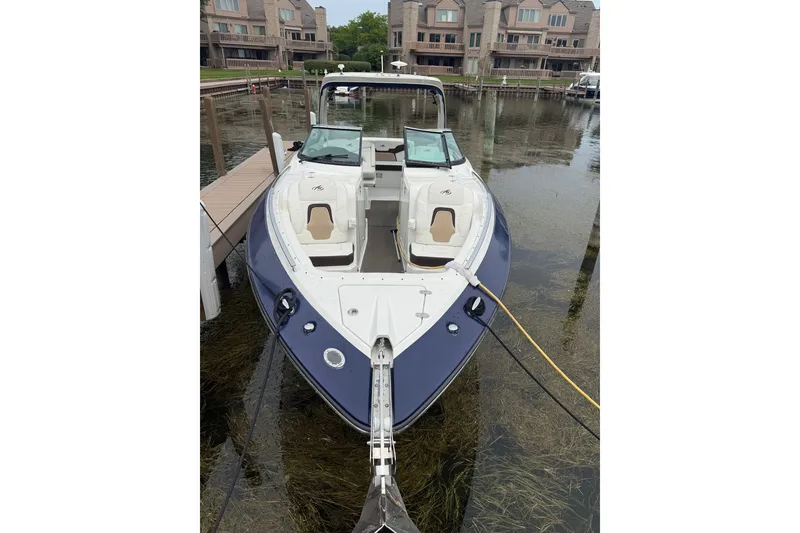 Slide: The Image of 2016 Monterey 328SS Super Sport boat docked in a marina with waterfront homes. - 1