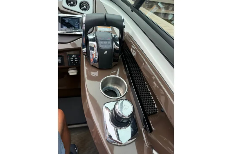 Slide: The Image of Control panel of a 2016 Monterey 328SS Super Sport boat with throttle and cup holder. - 26