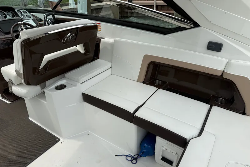Slide: The Image of Interior of a 2016 Monterey 328SS Super Sport boat with white and brown seating. - 12