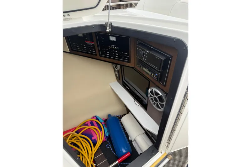 Slide: The Image of Interior of 2016 Monterey 328SS Super Sport boat with control panel and storage. - 19