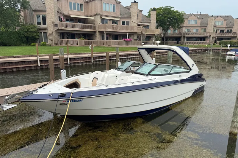 The Image of 2016 Monterey 328SS Super Sport boat docked near waterfront homes. - 0