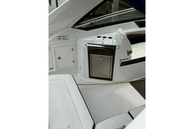 Slide: The Image of Interior of a 2016 Monterey 328SS Super Sport boat, featuring seating and storage. - 8