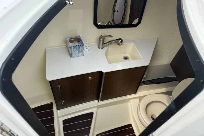 Slide: The Image of 2016 Monterey 328SS Super Sport boat bathroom with sink, mirror, and toilet. - 21