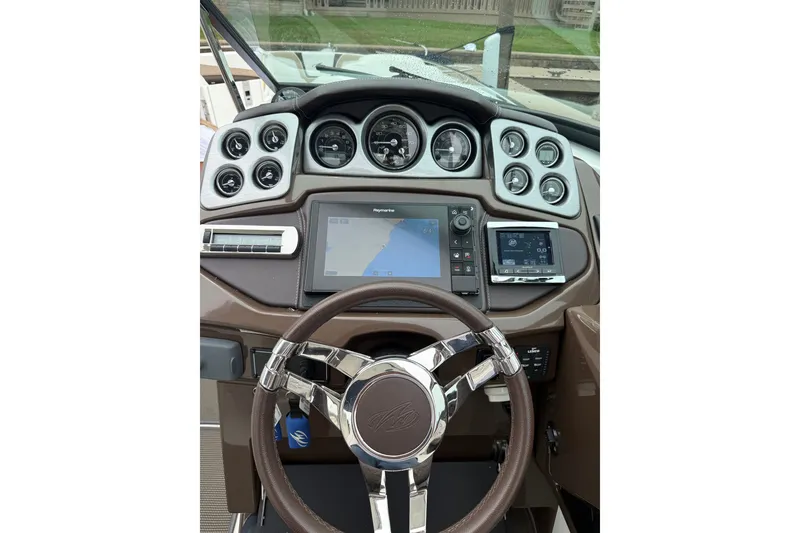 Slide: The Image of Dashboard of a 2016 Monterey 328SS Super Sport boat with steering wheel and navigation controls. - 30