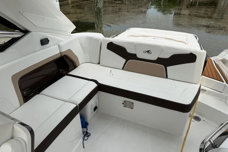Slide: The Image of 2016 Monterey 328SS Super Sport boat interior with white and brown seating. - 11