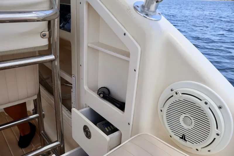 Slide: The Image of Interior view of a 2003 Scout 280 Abaco boat, featuring storage and speaker. - 14