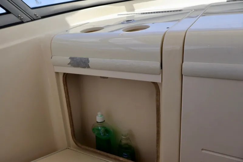 Slide: The Image of Interior storage compartment of 2003 Scout 280 Abaco boat with cleaning supplies. - 13