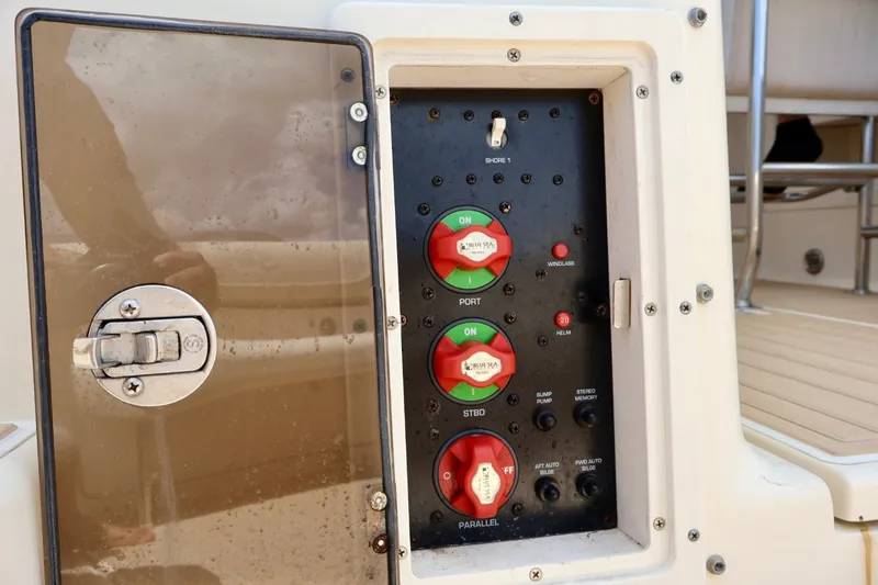 Slide: The Image of Control panel on a 2003 Scout 280 Abaco boat with switches and dials. - 7