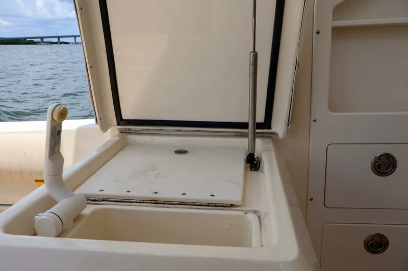 Slide: The Image of Open storage compartment on 2003 Scout 280 Abaco boat with water view. - 12