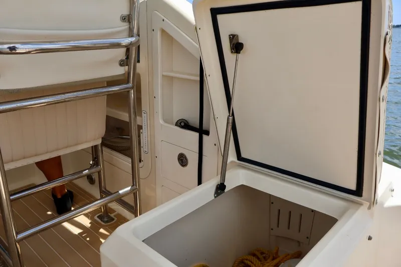 Slide: The Image of Open storage compartment on 2003 Scout 280 Abaco boat with visible ladder and rope. - 11