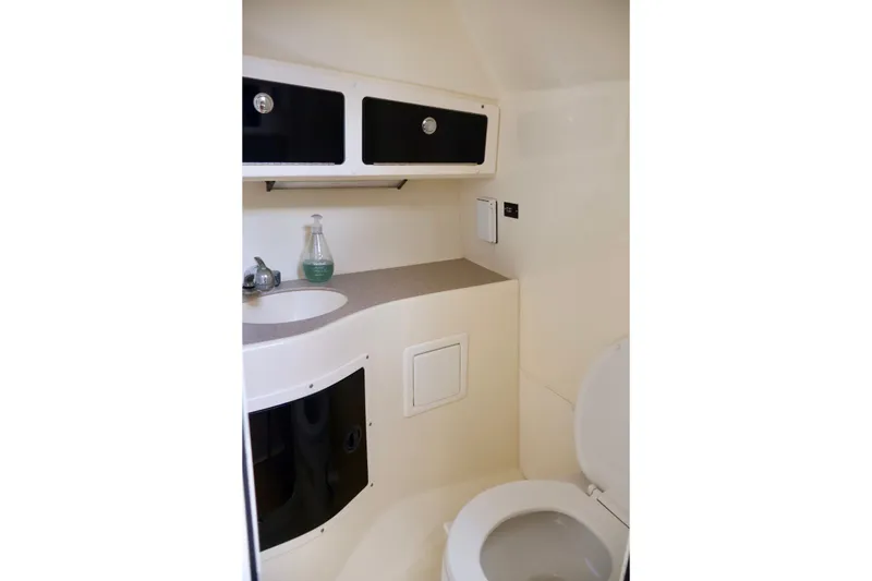 Slide: The Image of Compact bathroom in 2003 Scout 280 Abaco boat with sink and storage cabinets. - 17