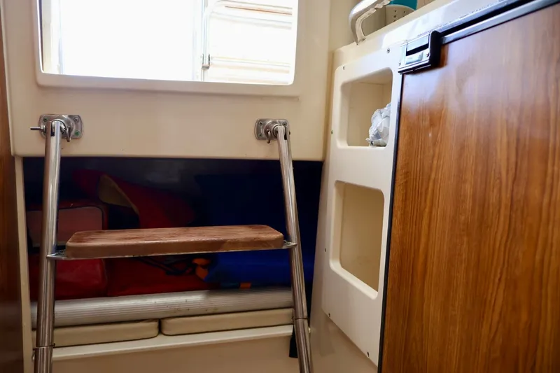 Slide: The Image of Interior of 2003 Scout 280 Abaco boat with wooden ladder and storage compartments. - 19