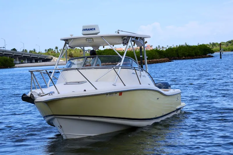 Slide: The Image of 2003 Scout 280 Abaco boat cruising on a scenic waterway near a bridge. - 4