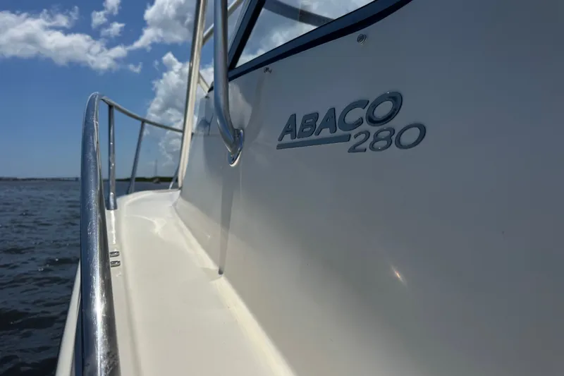 Slide: The Image of 2003 Scout 280 Abaco boat on water, showcasing sleek design and branding. - 27