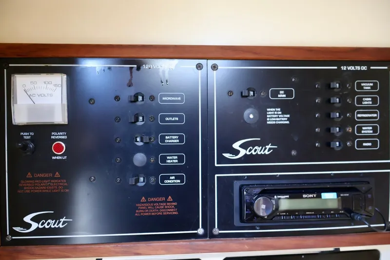 Slide: The Image of Control panel of a 2003 Scout 280 Abaco boat with various switches and gauges. - 18