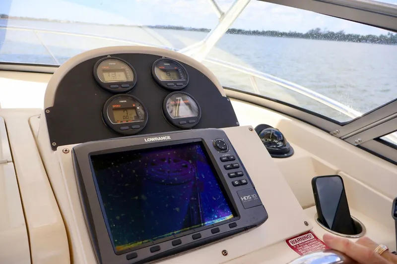 Slide: The Image of Dashboard of 2003 Scout 280 Abaco boat with navigation instruments and Lowrance display. - 10