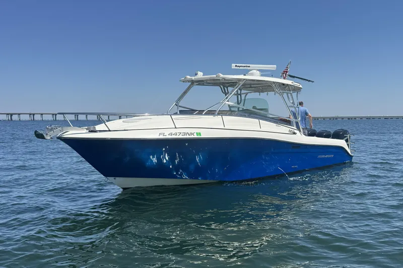 The Image of 2005 Hydra-Sports Vector 3300 VX boat on water, clear sky, bridge in background. - 0
