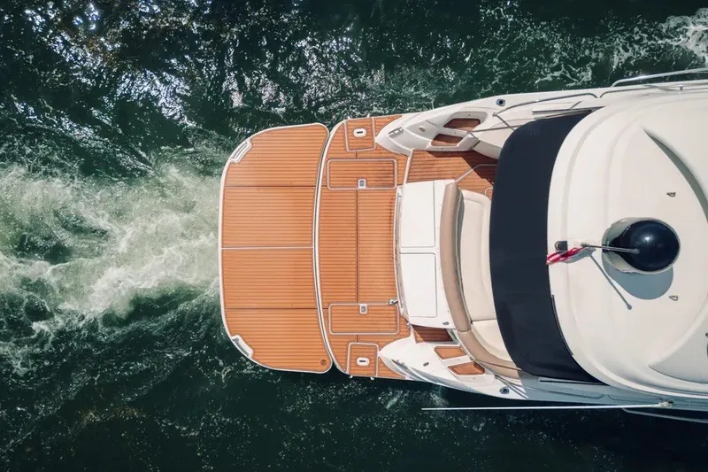 Slide: The Image of Aerial view of 2009 Four Winns V458 yacht on water with wooden deck. - 3