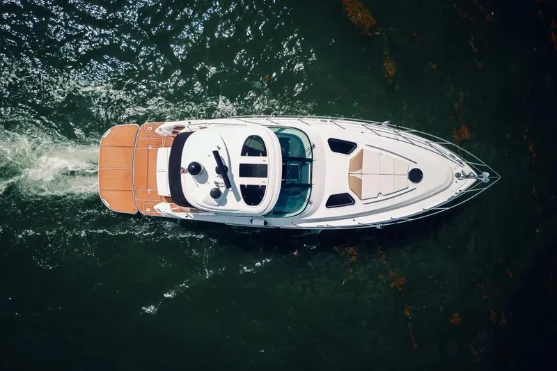 Slide: The Image of Aerial view of 2009 Four Winns V458 yacht cruising on water. - 2