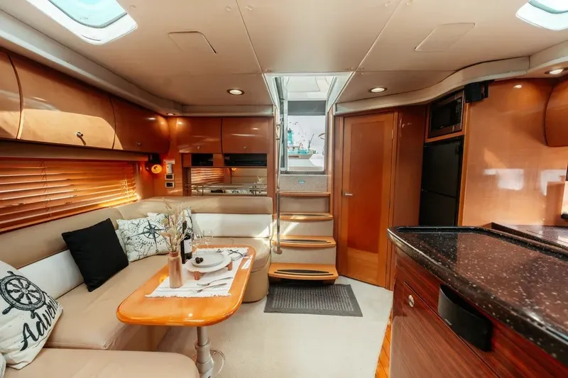 Slide: The Image of Luxurious 2009 Four Winns V458 yacht interior with elegant seating and dining area. - 7