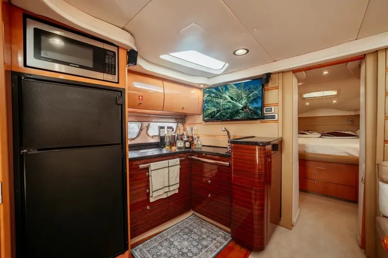 Slide: The Image of Luxurious 2009 Four Winns V458 yacht interior with modern kitchen and cozy bedroom. - 9